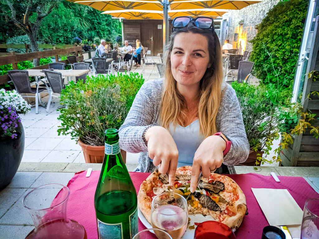 Breanne eating pizza at sequioia parc campsite