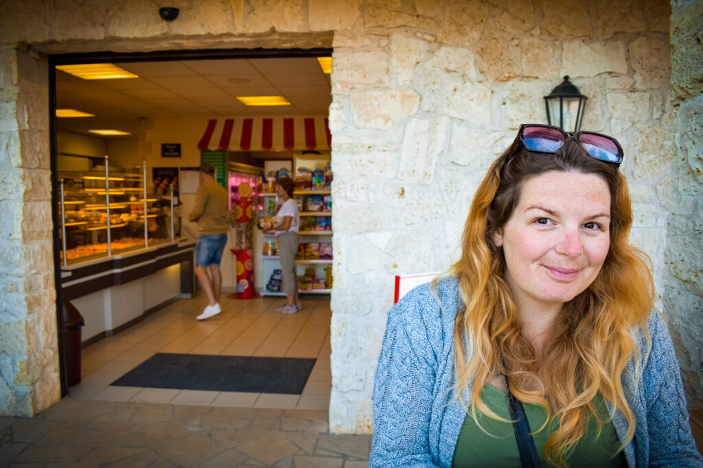 Breanne sat outside the bakery at La Croix du vieux pont berny riviere france (17)