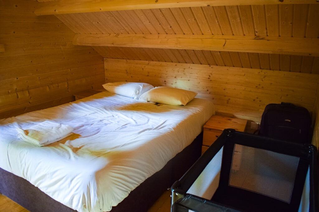 upstairs double bedroom in our lakeview wooden villa lodge at la croix du vieux pont berny riviere