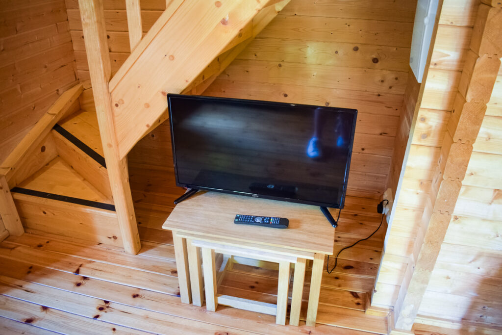 TV on the table under the stairs in our 4 bed wooden villa lodge at la croix du vieux pont berny riviere