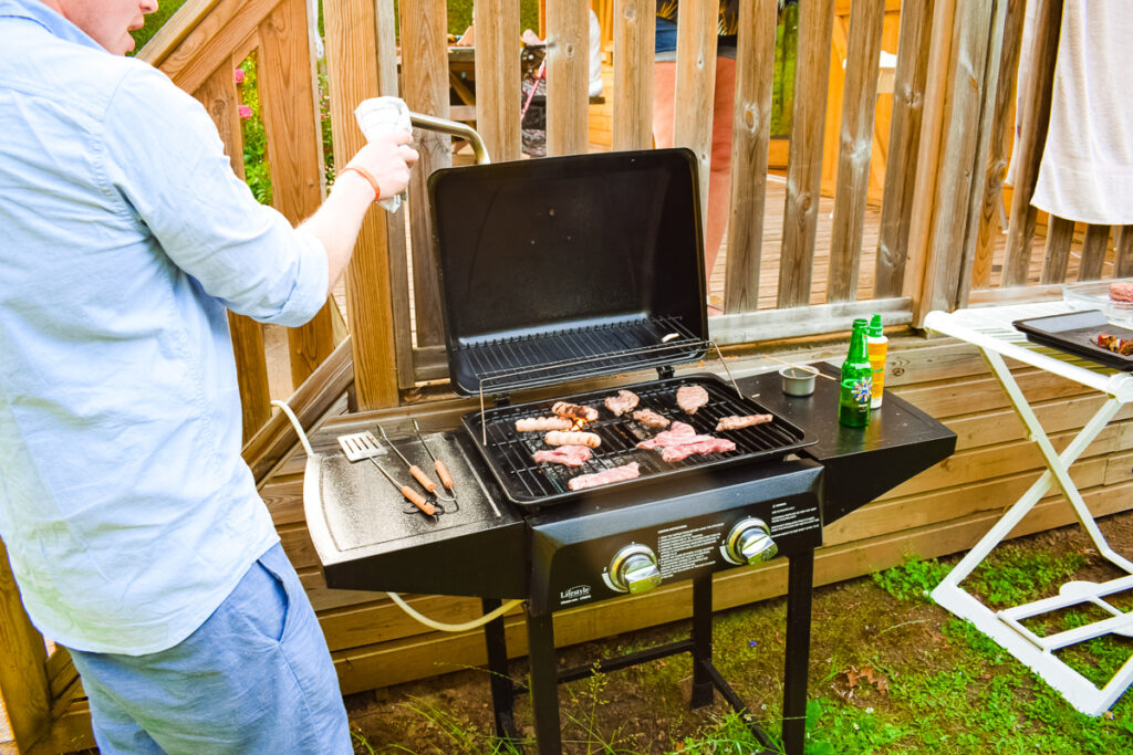 mike doing the bbq at our wooden lodge at la croix du vieux pont campsite in france