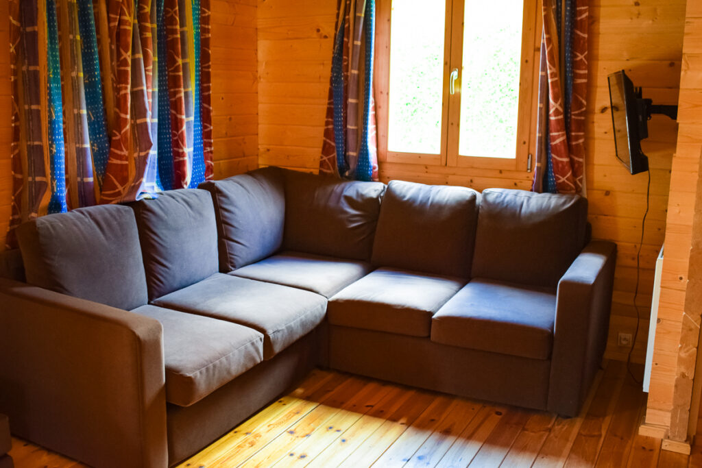 Sofa area of the 4 bedroom villa lodge at la croix du view pont campsite with eurocamp in the village of berny riviere france