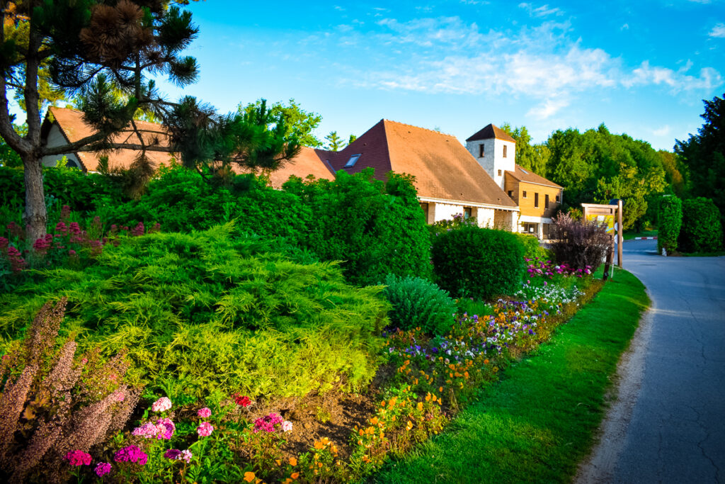 The flowers and bushes on the way to the main reception at La Croix du vieux pont berny riviere france the campsite gardens are very well maintained