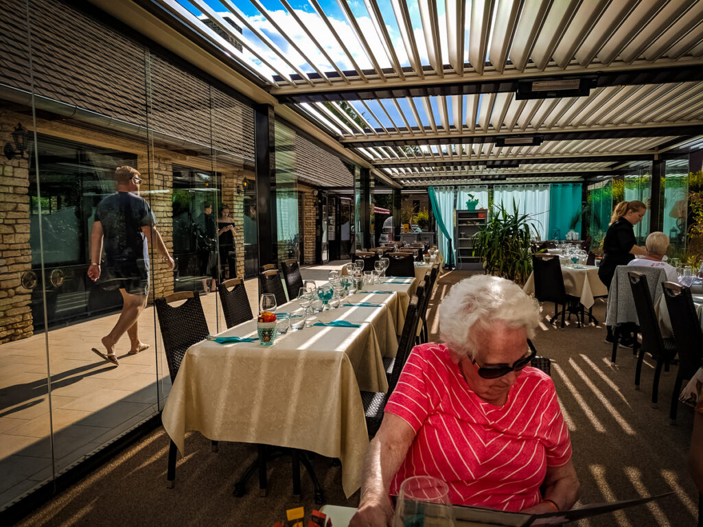 breannes nan browsing the menu inside the restaurant at La Croix du vieux pont berny riviere france (51)