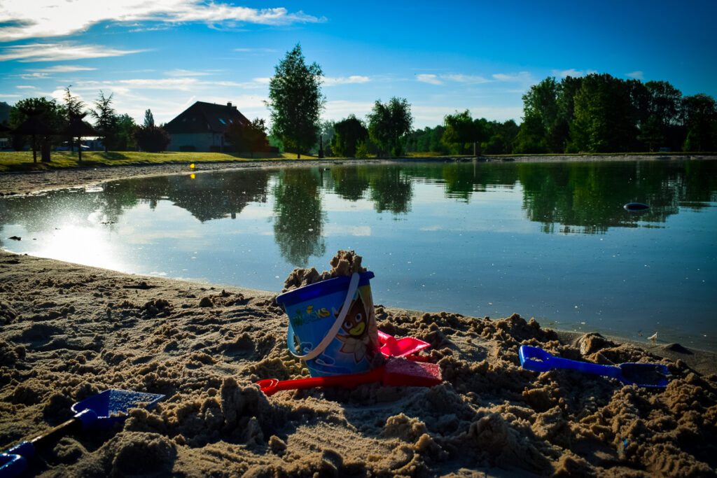 bucket and spade on the beachfront of the beach lake at La Croix du vieux pont berny riviere france (24)