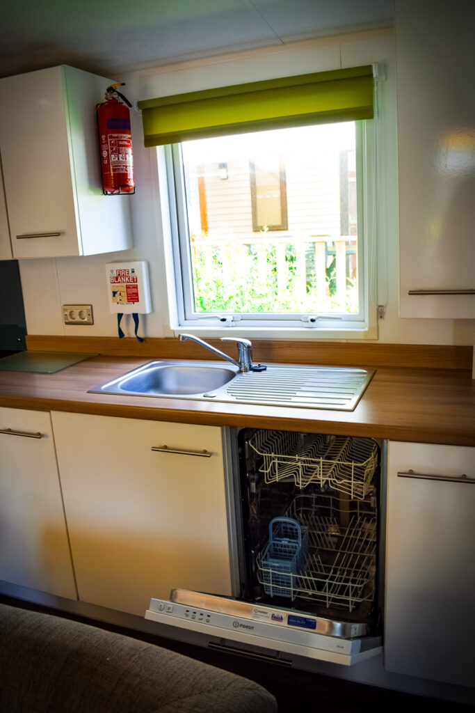 dishwasher in the kitchen at camping la garangeoire staying in an aspect mobile home with eurocamp