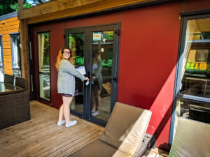 Breanne stood outside on the decking of the aspect mobile home by eurocamp at camping la garangeoire
