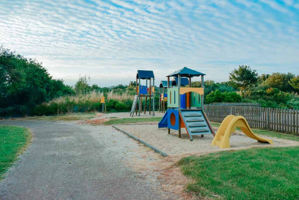 Play park with climbing frame and kids yellow slide at Camping de l'ocean Brem Sur Mer