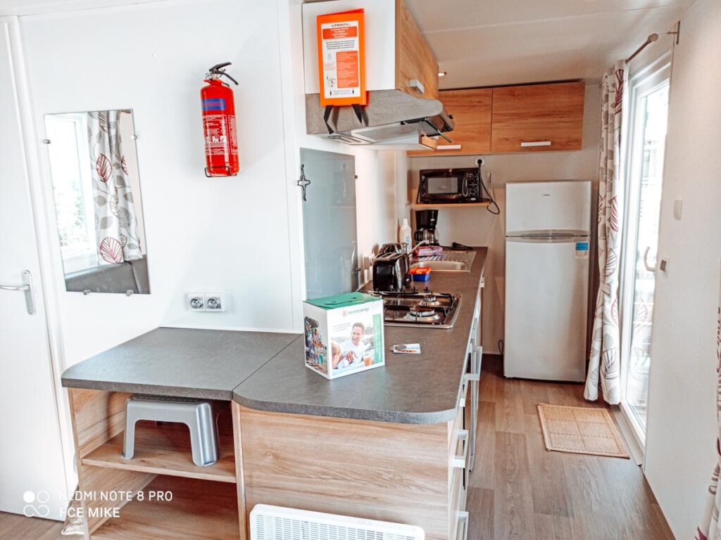 Kitchen in our Eurocamp PREMIUM (Formerly Azure Plus) 2 bedroom from Eurocamp at Camping des menhirs-11