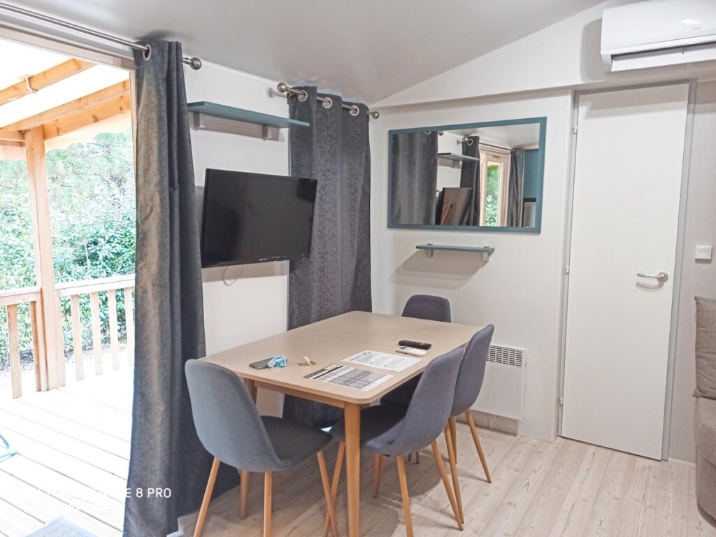 Dining table with TV in our premium cottage at camping natureo in hossegor-09