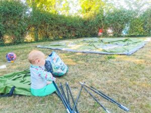 Baby building a tent at Mansle campsite in the Charente France.