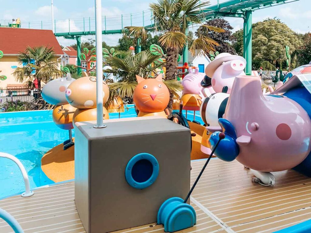 Paultons-park-and-peppa-pig-world photo from granpa pigs sailing club of grandpa pig lying on a boat and other characters in the background