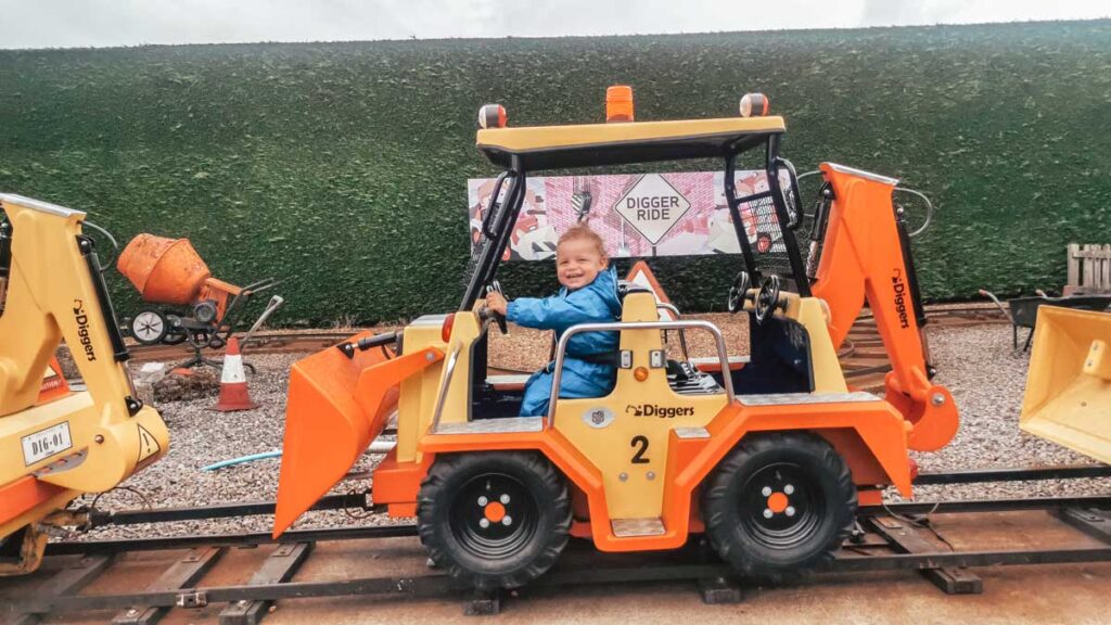 toddler on the digger ride at Paultons-park-and-peppa-pig-world