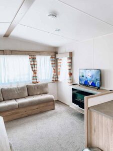 main-living-area-with-TV-and-fireplace-in-our-classic-caravan-at-Hoburne-holiday-bashley-holiday-park