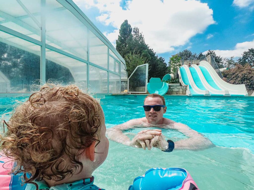 Mike-and-the-toddler-at-the- slides pool-on-domaine-de-la-breche-campsite