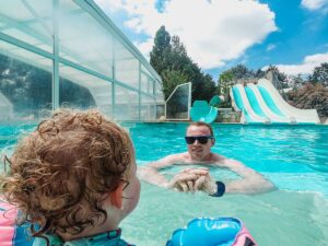 Mike-and-the-toddler-at-the- slides pool-on-domaine-de-la-breche-campsite
