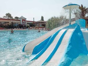 kids-splash-slide-outside-swimming-pool-at-yelloh-village-sylvamar