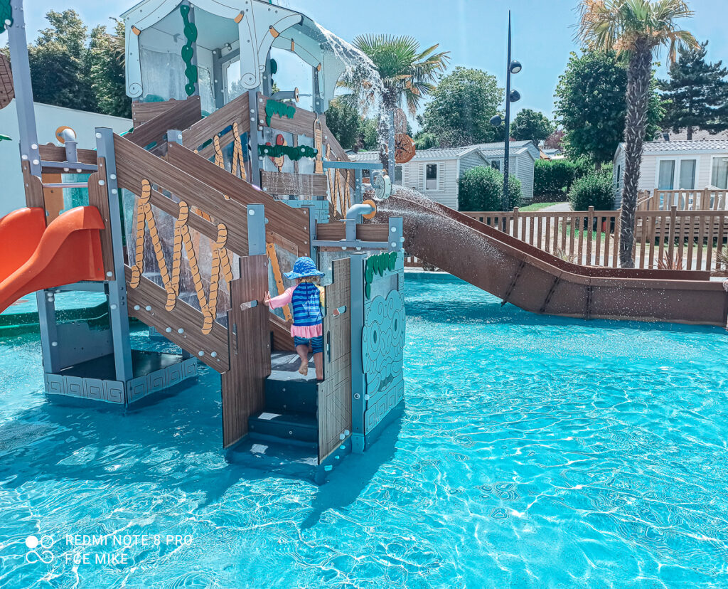 Toddler playing on the splash park at Marvilla Parks La Vallee