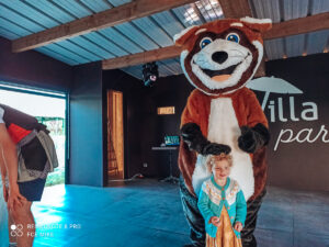 Toddler with the mini disco mascot for homair and marvilla parks campsites