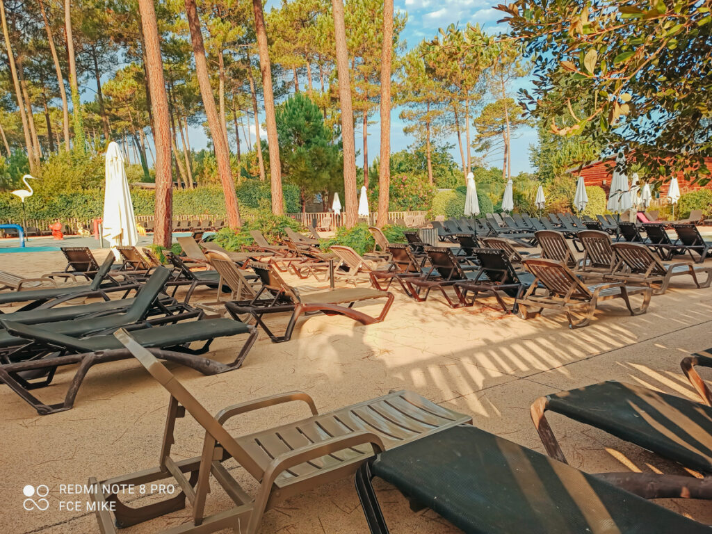 lots of pool sunloungers at sandaya soustons village campsite -21