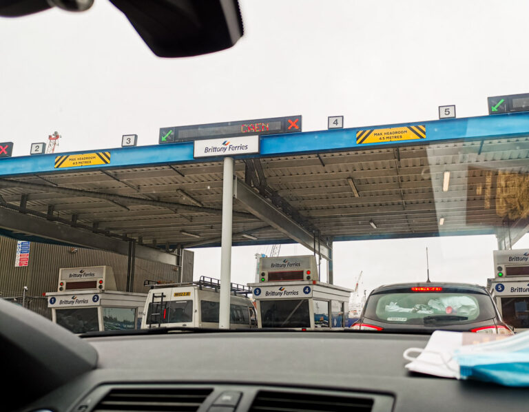 Car parked under a fuel station canopy