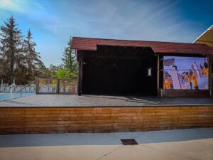 Kids club stage at grand dague with a tv screen on it