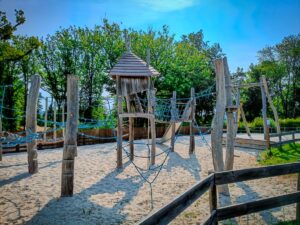 the sanded play park at grand dague campsite featuring wooden structures