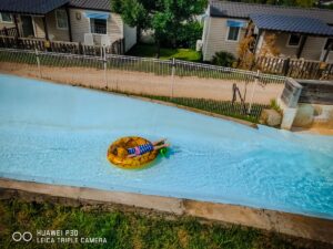 lazy river slide at grand dague with a child on a rubber ring
