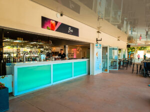 bar area at la yole with man working behind bar