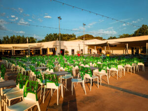 the outdoor bar area seating at la yole with green and white chairs