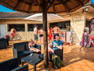 sitting outside the pool bar area of Le Lac des 3 Vallées