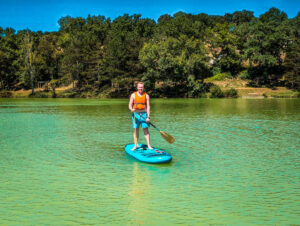 Mike on a paddleboard at Le Lac des 3 Vallées