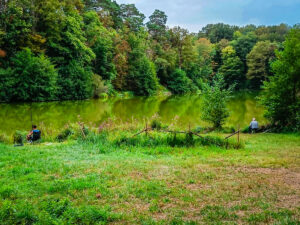 men fishing at the lake on parc de fierbois