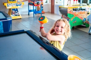 playing air hockey at the campsite arcade