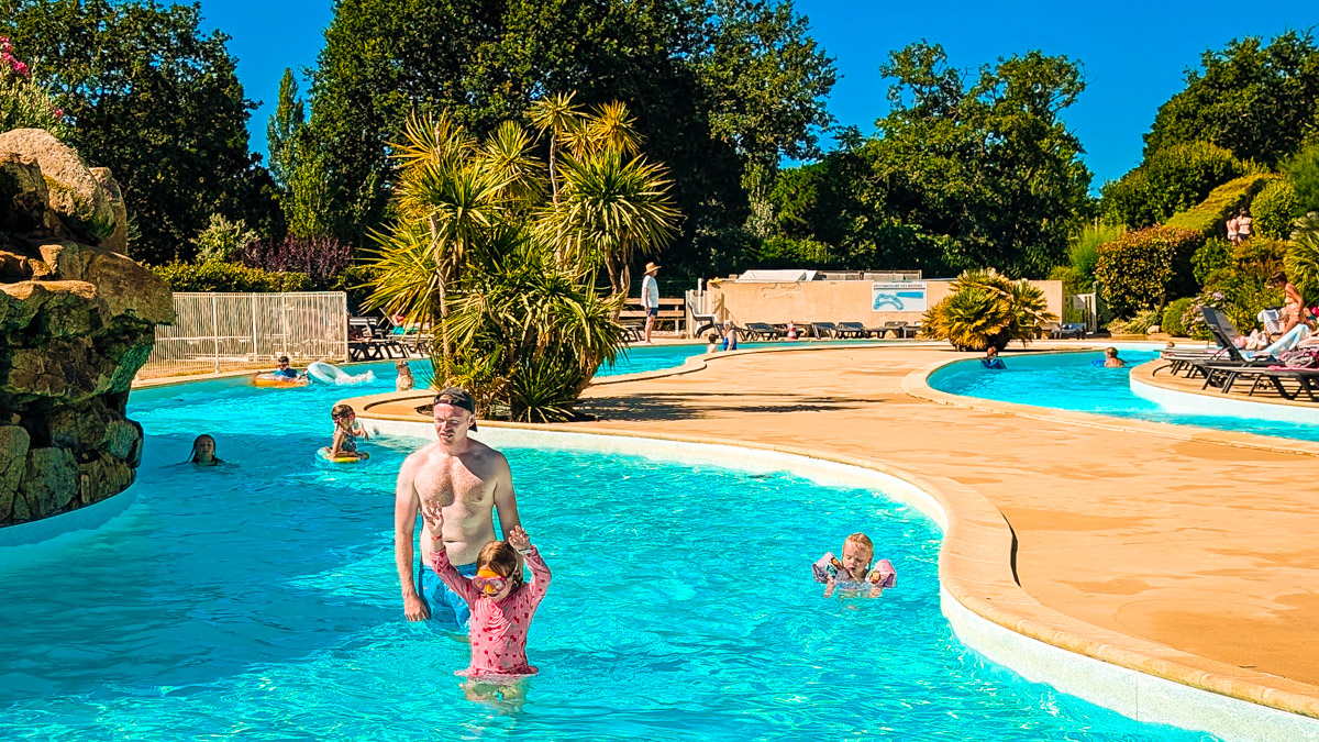family in the lazy river pool at Eurocamp At Camping Homair La Grande Metairie