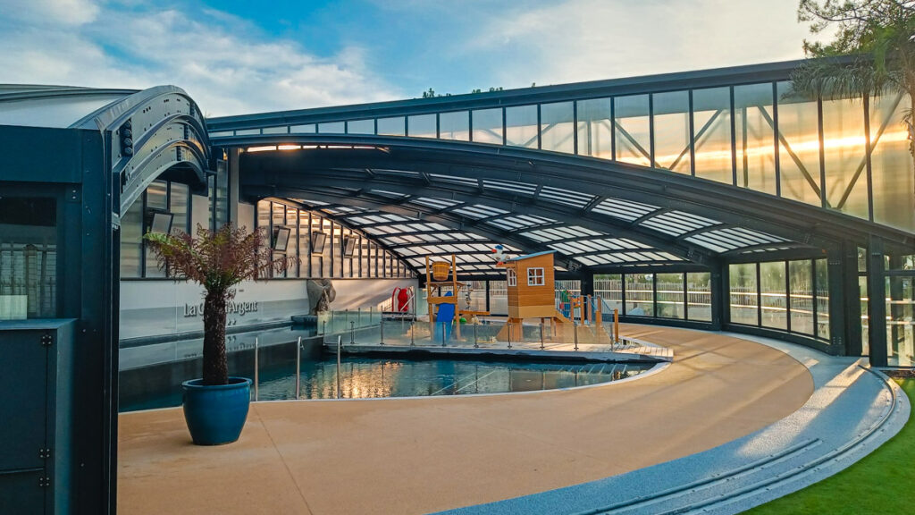 The indoor covered and retractable pool area with childrens play equipment