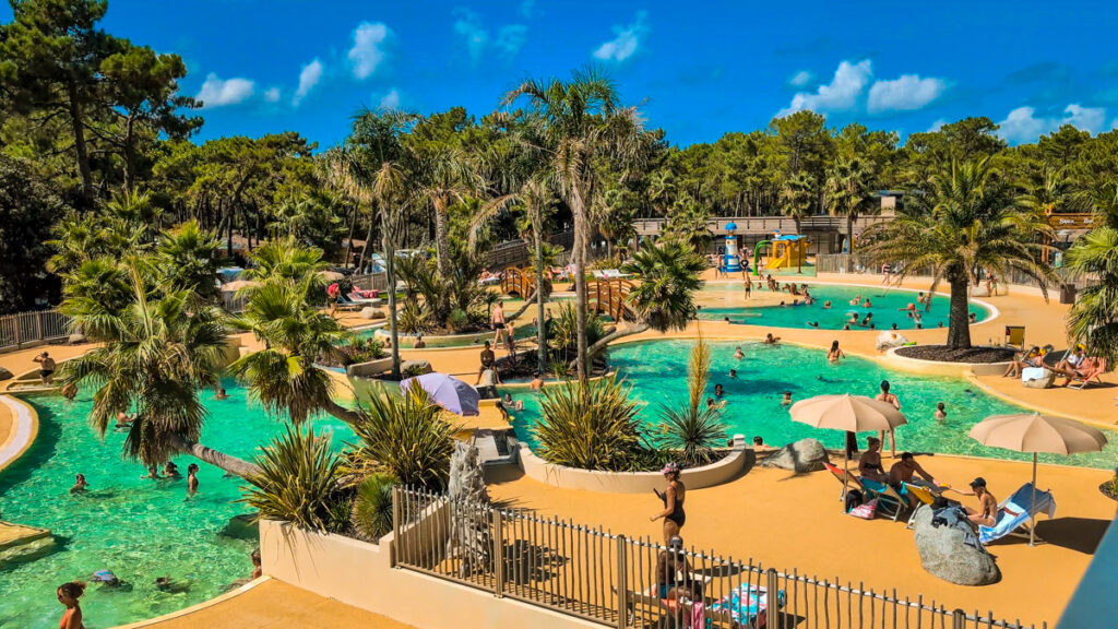 a swimming pool at camping cote d'argent photo taken from above showing lots of people