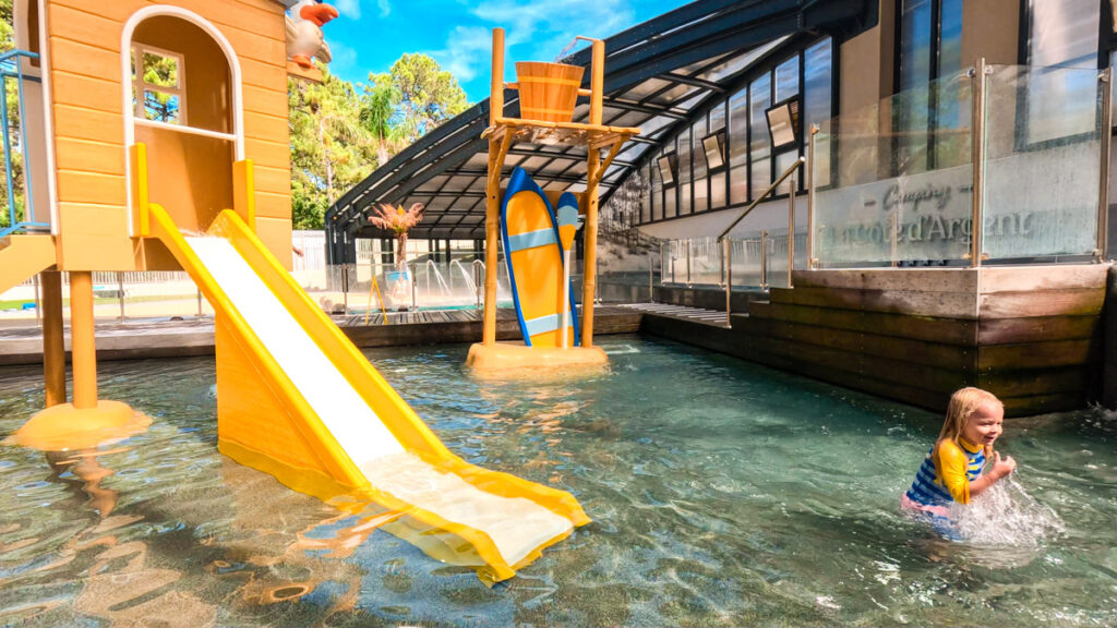 The indoor covered and retractable pool area with childrens play equipment