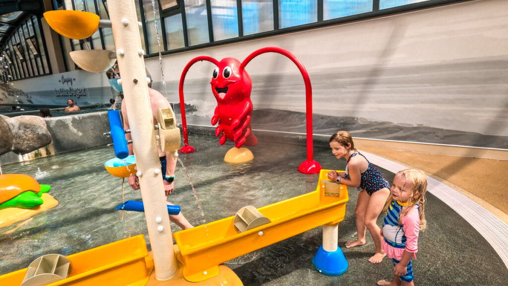 The indoor covered and retractable pool area with childrens play table for water activities