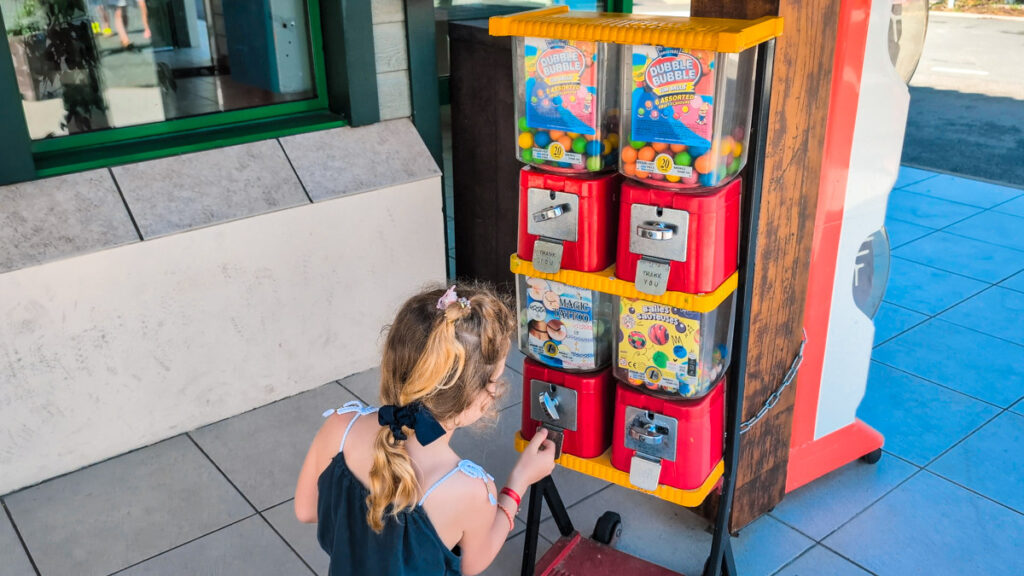 child getting toy from a vending machine at camping cote d'argent