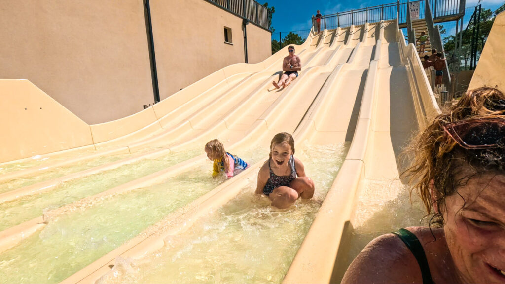 Family going down the waterslides at camping cote d'argent