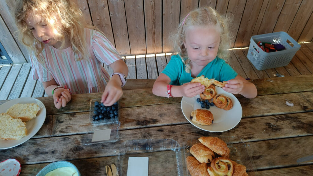 Our girls eating breakfast at the table on the decking