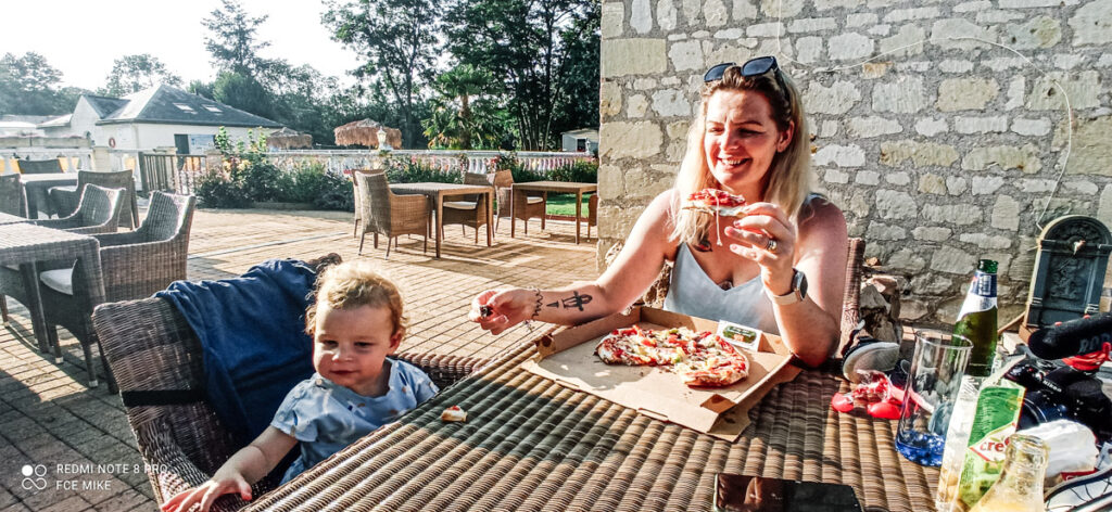 Tucking into campsite pizza on the decking