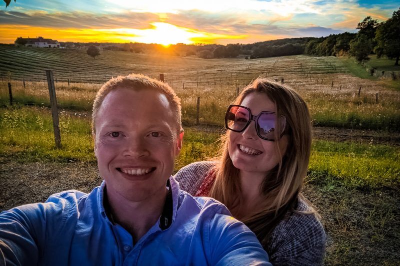 Mike and Breanne from Family Camping Europe Mike and Breanne from Family Camping Europe on a campsite with dordogne fields and a sunset in the background